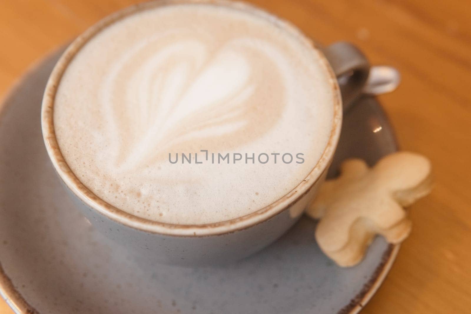 Coffee on a wooden table in a cafe, drawings on coffee