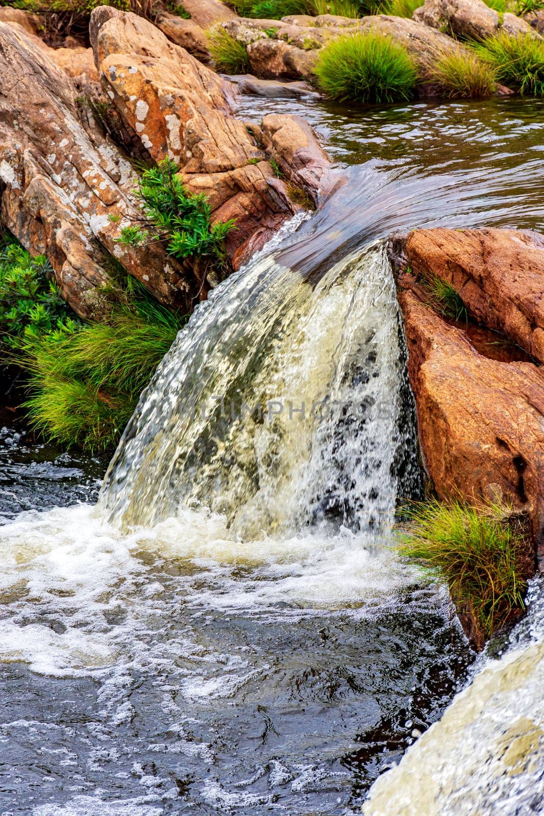 Small waterfall with dark waters between the rocks in Minas Gerais, Brazil