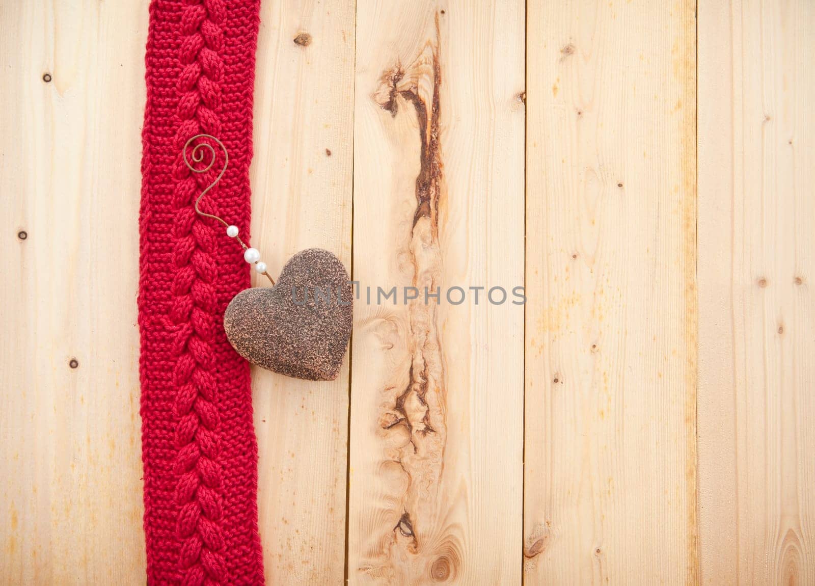 Background in rustic wood with knitted braid pattern in red