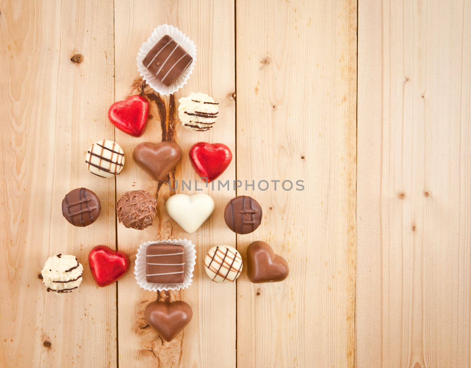 Various chocolates and trueffel on rustic background made of wood