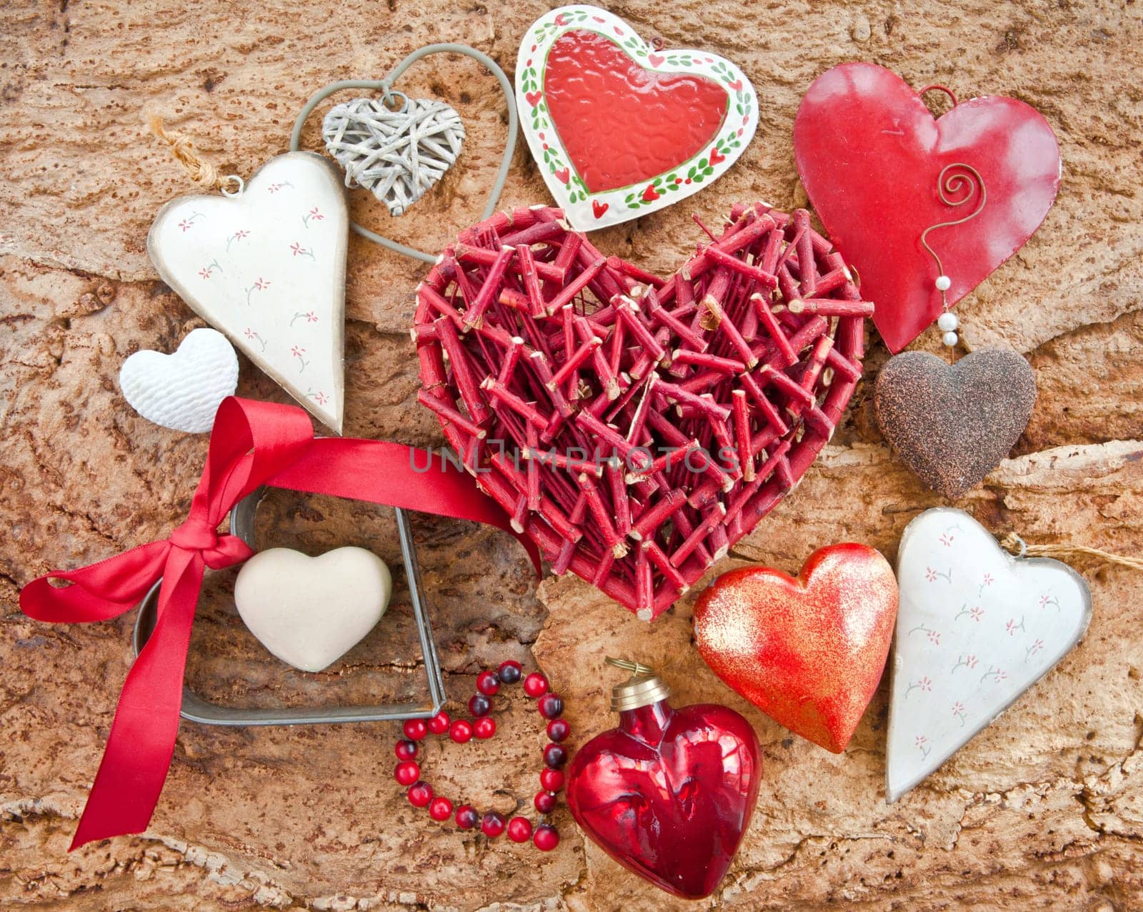 Various red hearts on rustic background made of wood