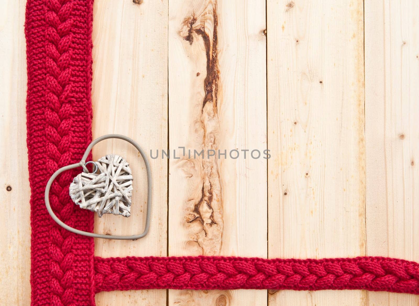 Background in rustic wood with knitted braid pattern in red