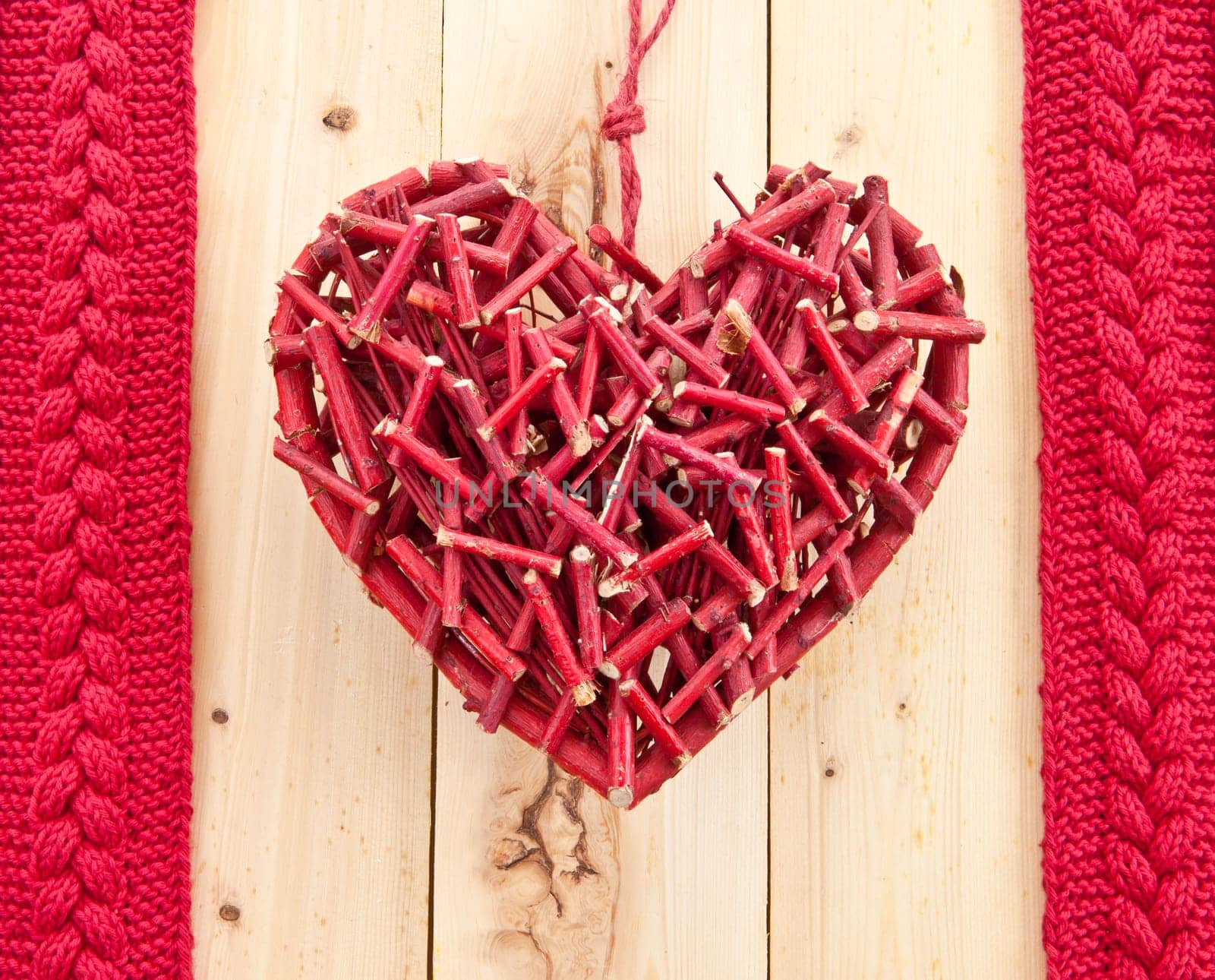 Red rustic heart on wooden background