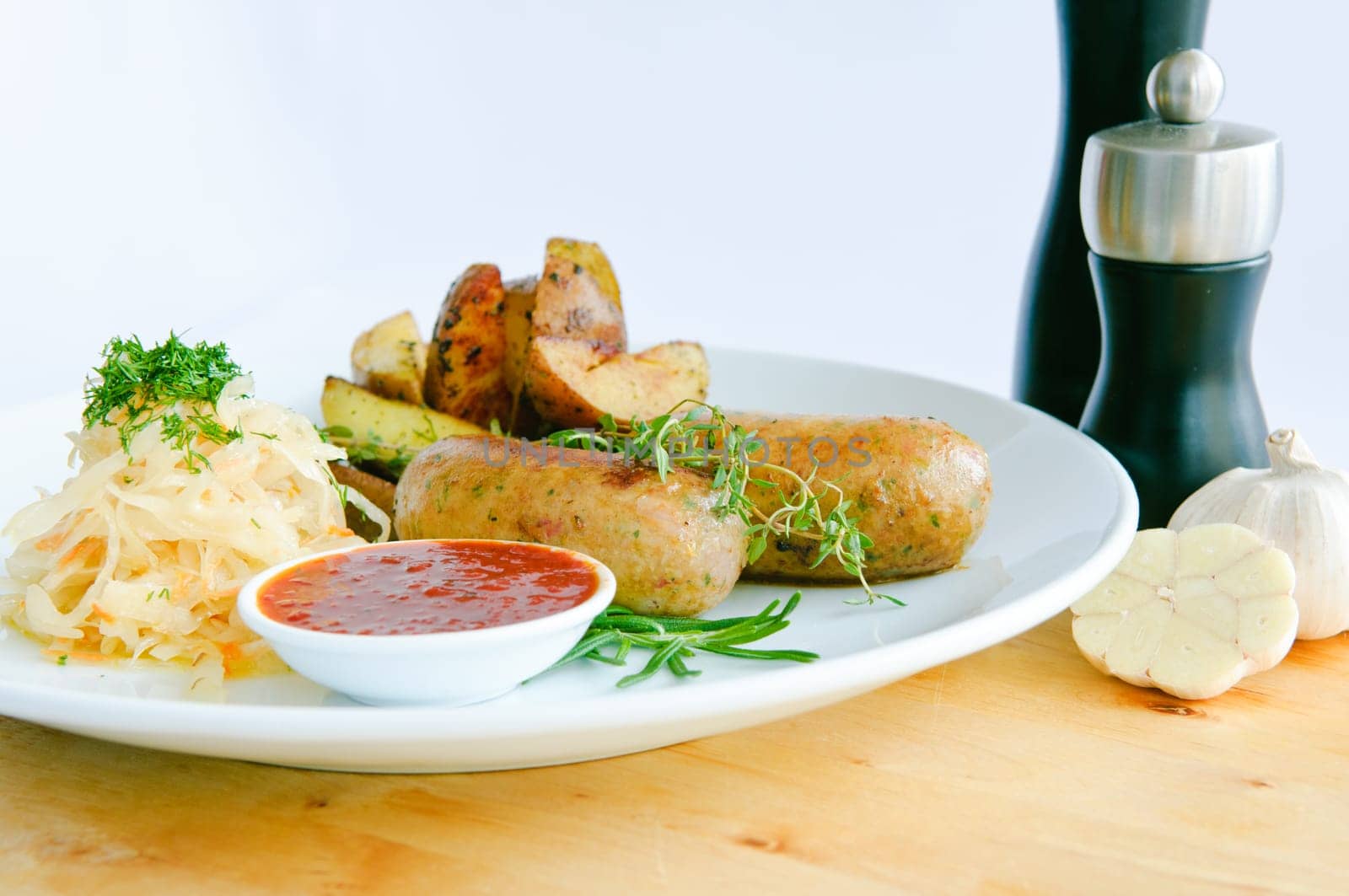 Italian Sausage with wegetables on dish and ketchup