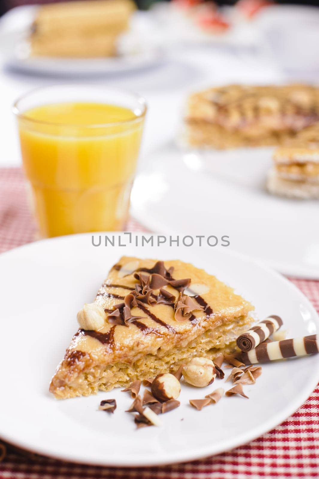Piece of cake with chokolate and juice on white plate