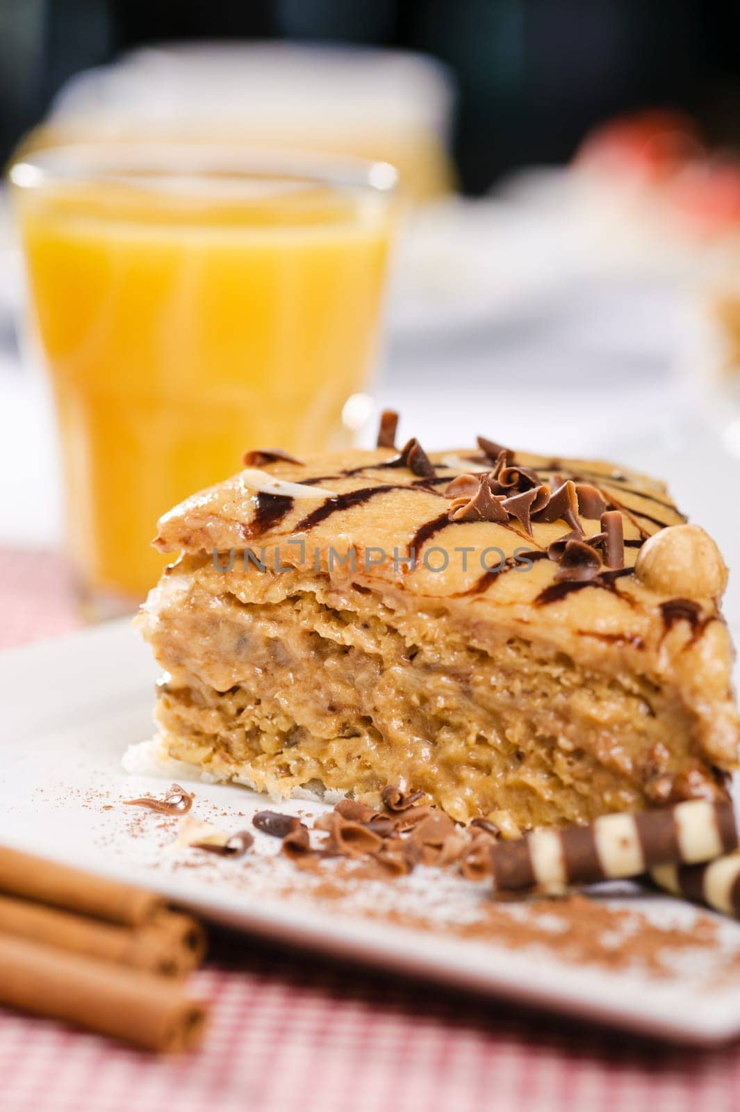 Piece of cake with chokolate and juice on white plate