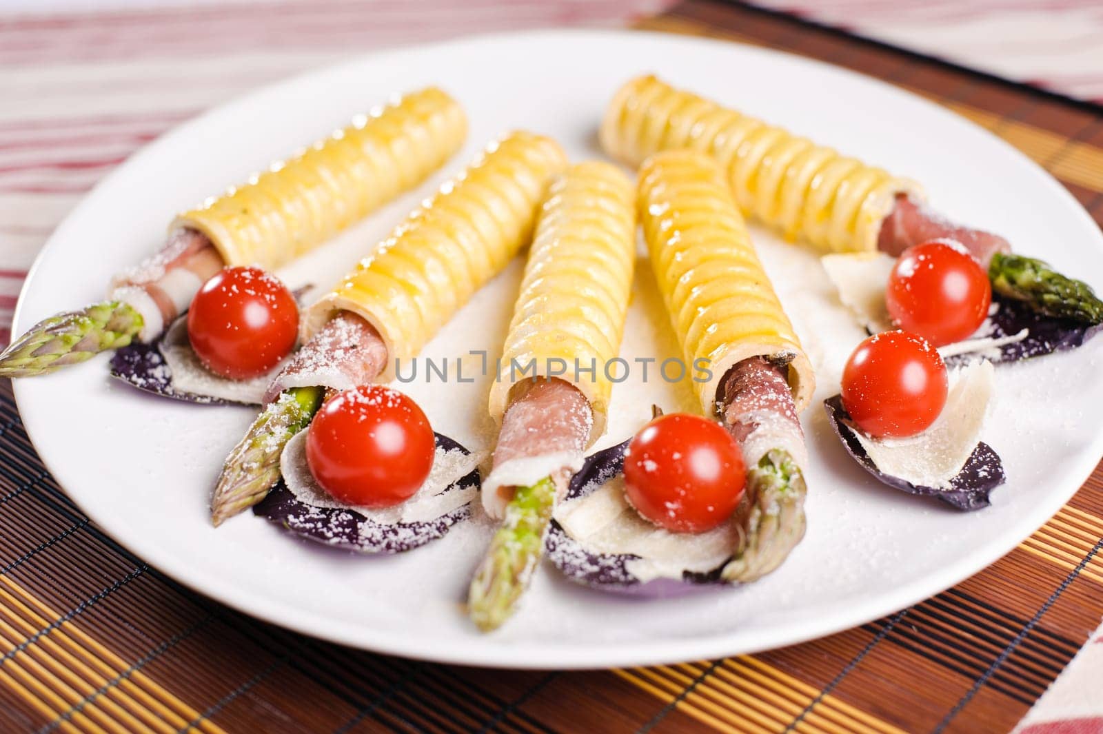 Few snaks on a plate with vegetables and bacon