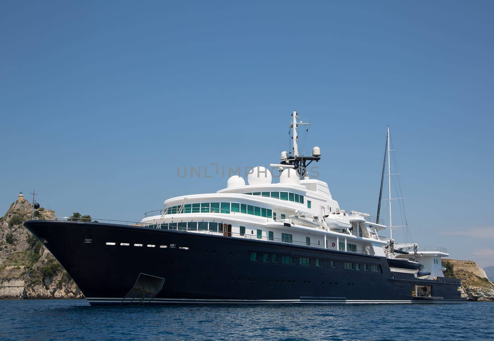 Gigantic big and large luxury yacht with sail boat and helicopter landing place on bord. Investment concept for millionaires.