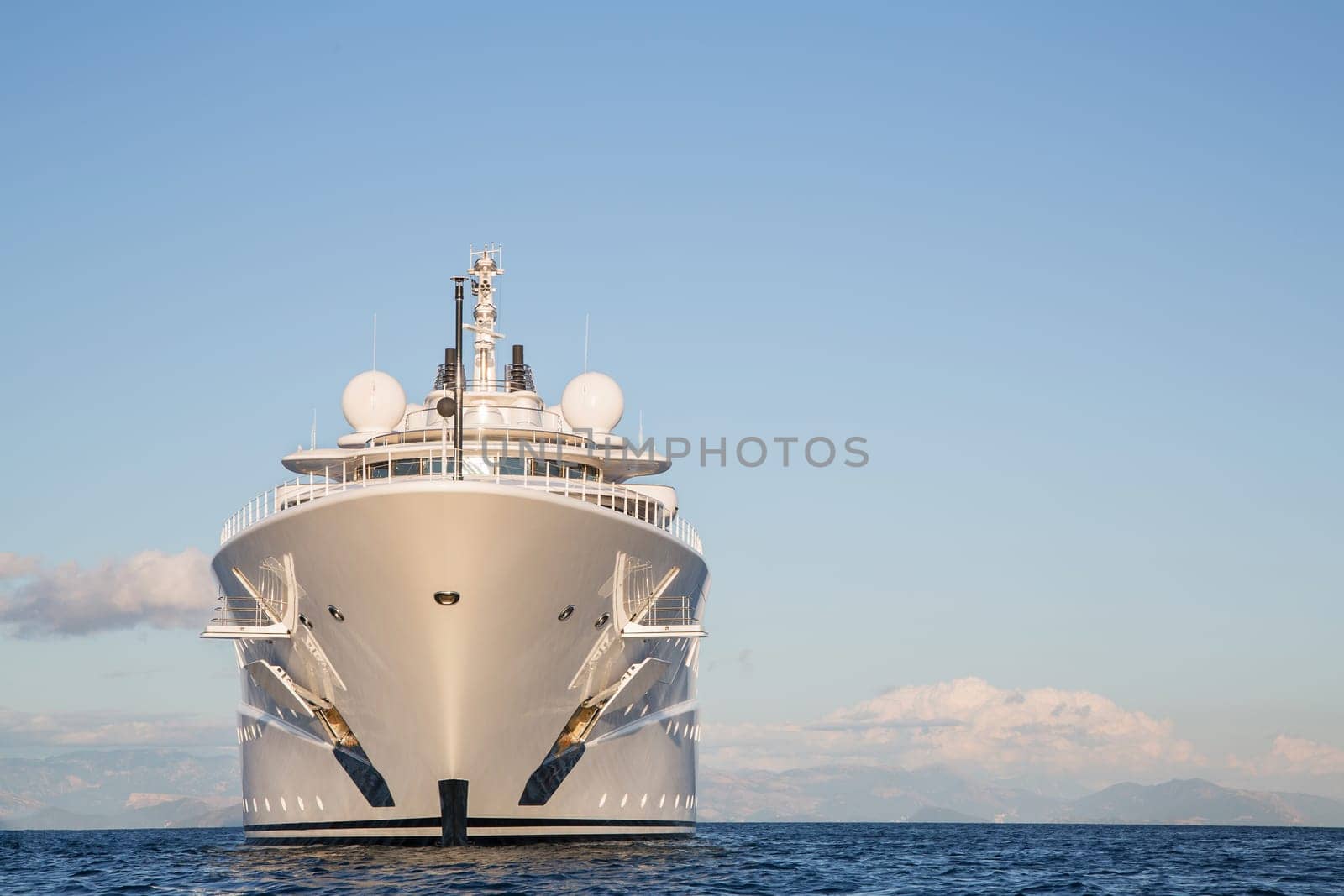 Gigantic big and large luxury mega or super motor yacht on the blue ocean.
