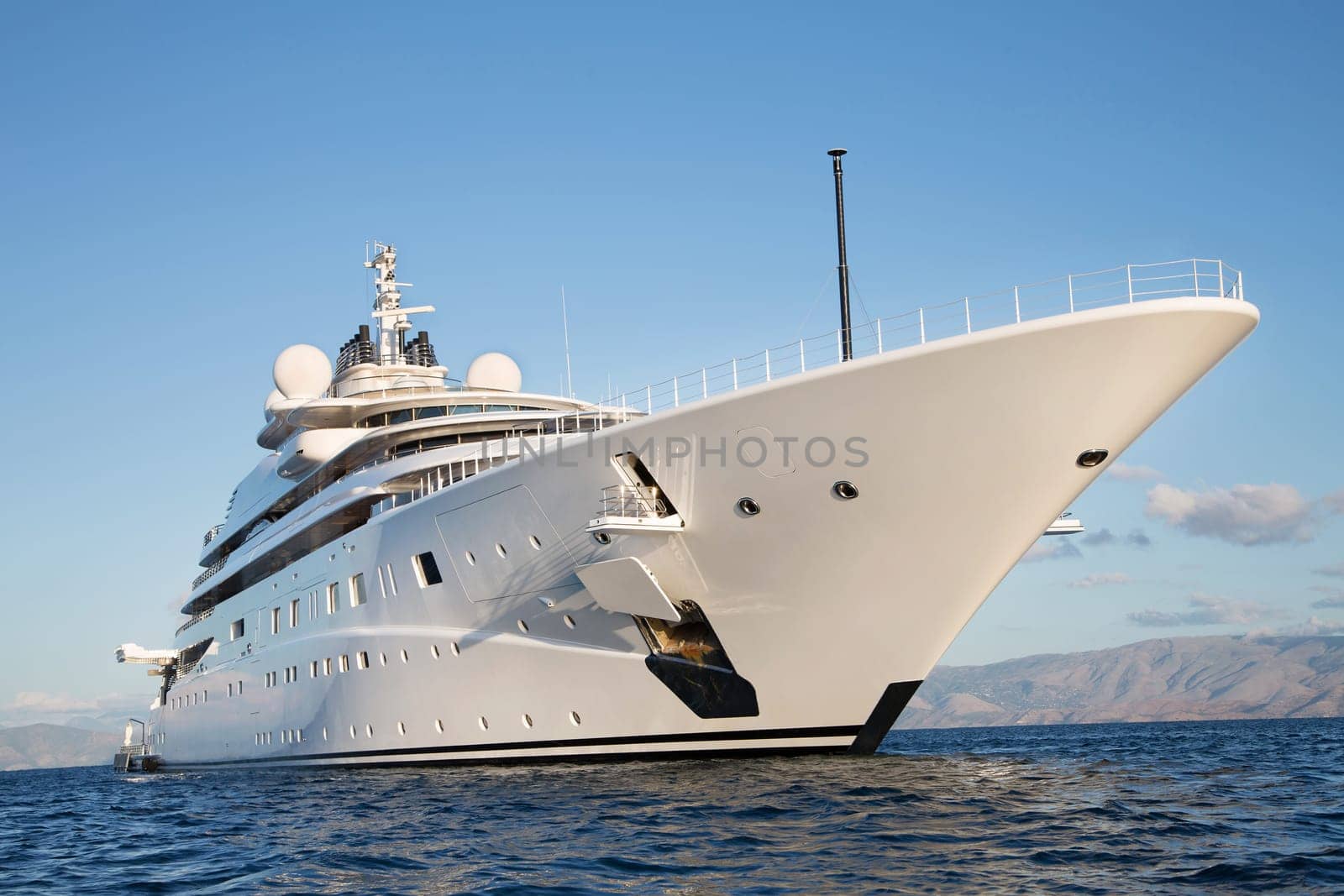 Gigantic big and large luxury mega or super motor yacht on the blue ocean.
