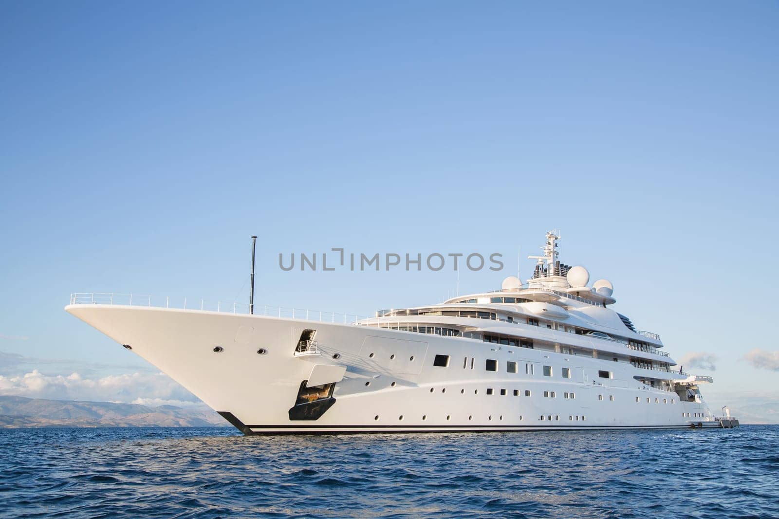 Gigantic big and large luxury mega or super motor yacht on the blue ocean.
