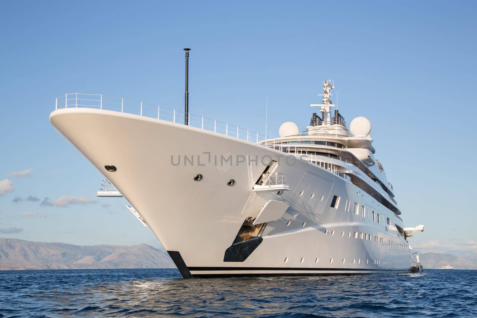 Gigantic big and large luxury mega or super motor yacht on the blue ocean.