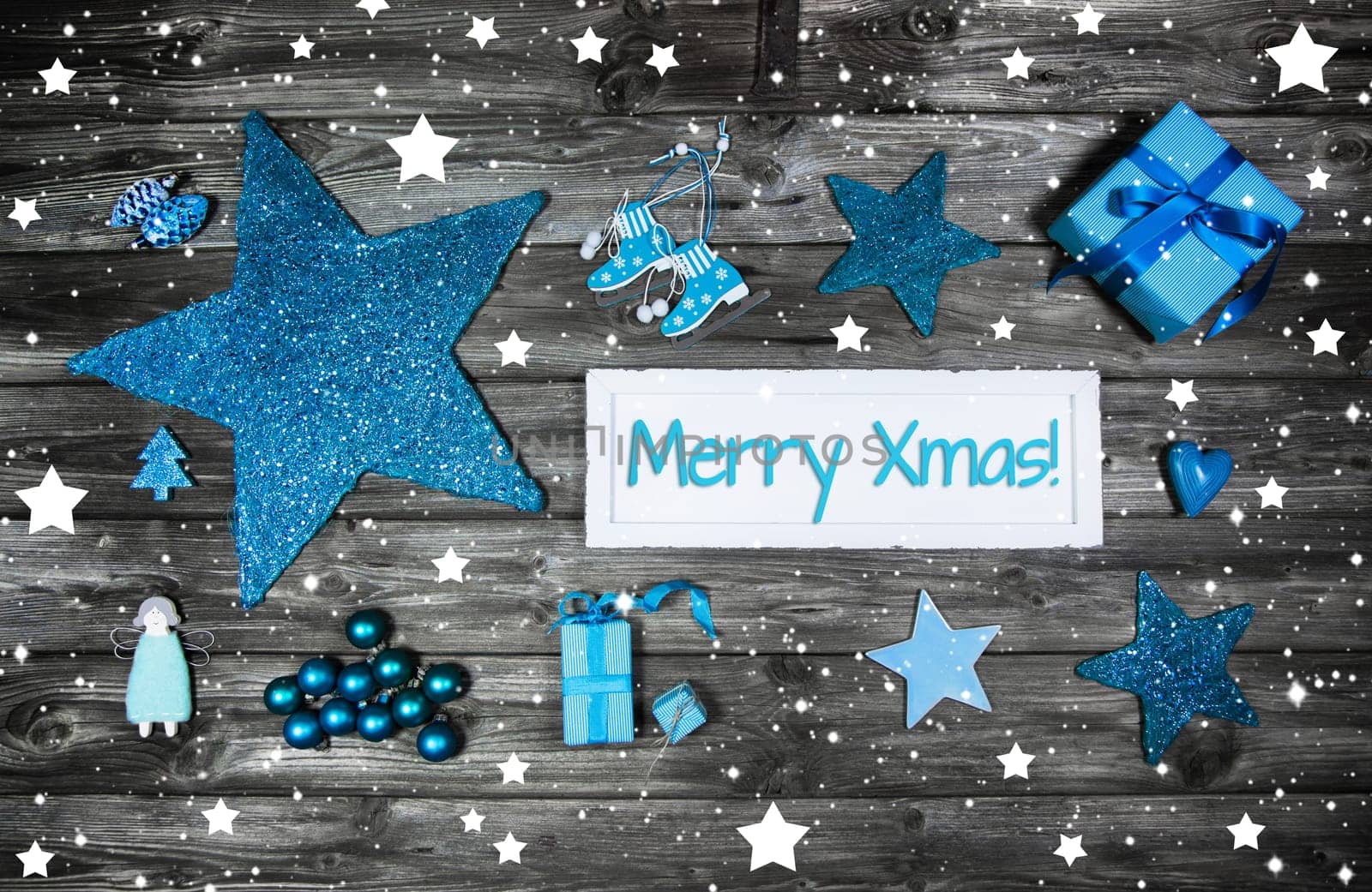 Merry christmas card or voucher. Xmas decoration in blue, white on grey wooden background with text.