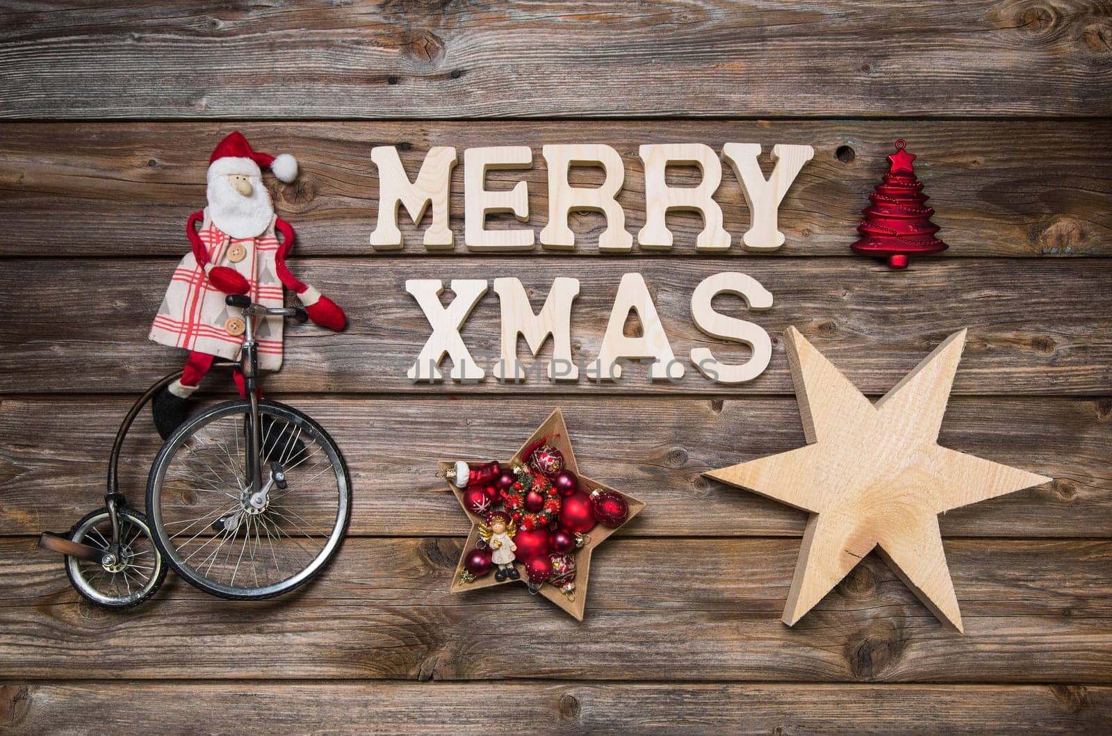 Merry Xmas greeting card with text. Red Santa Claus on wooden rustic background with stars.