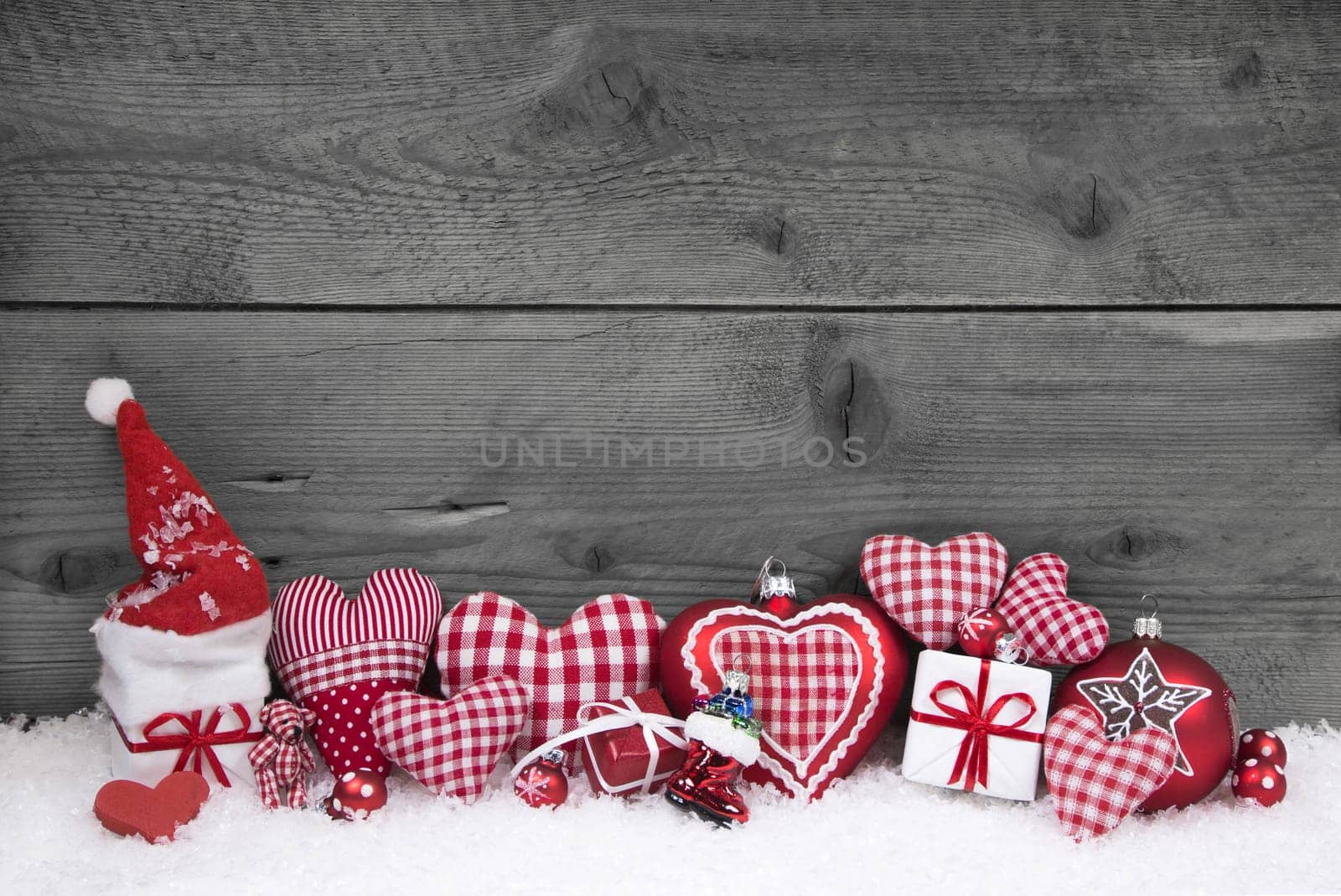 Red white checked christmas decoration on grey wooden shabby background.