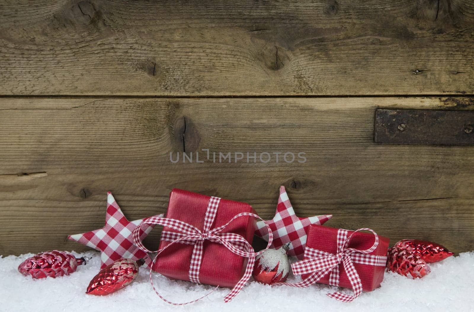 Presents for christmas in red white checkered color on wooden old country style background.