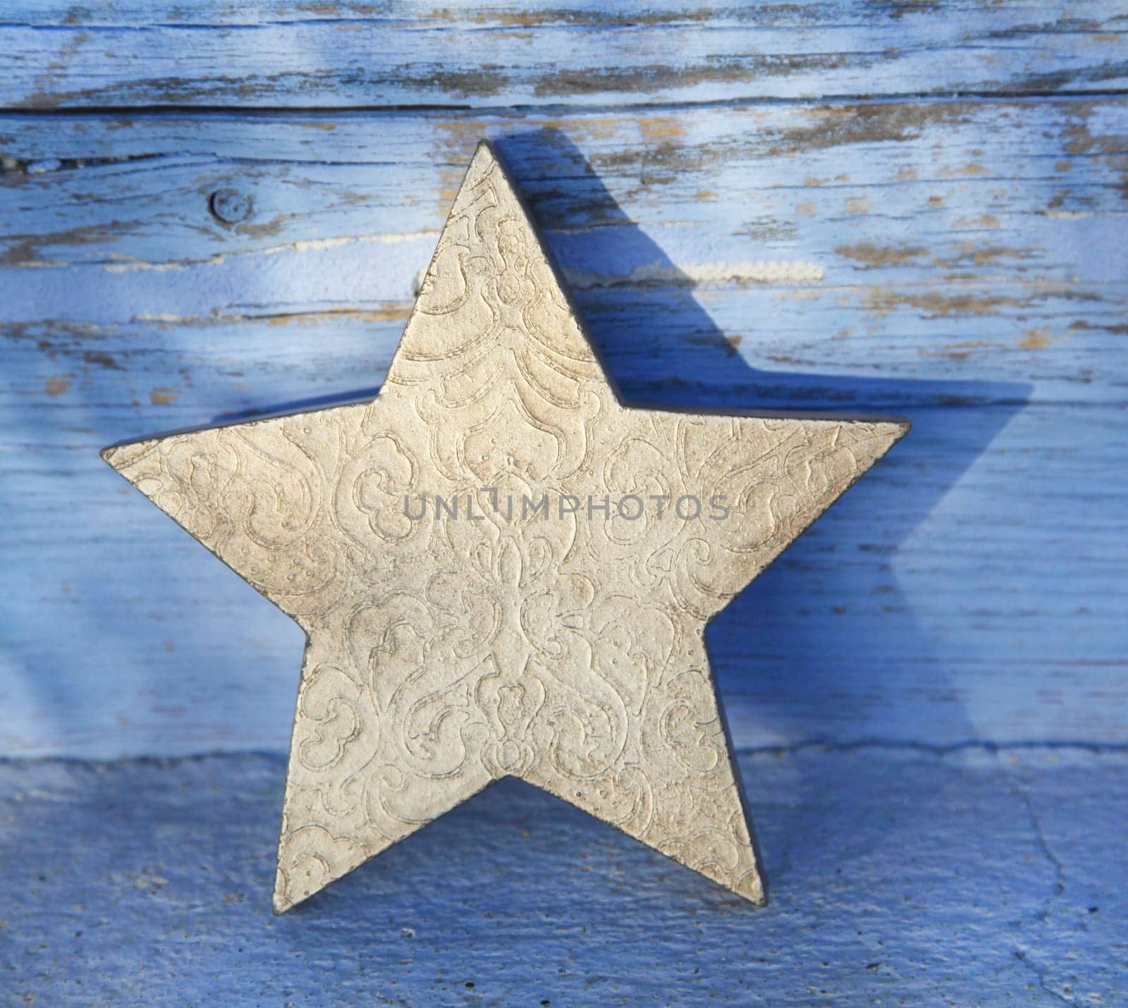 One old golden wooden christmas star for decoration.