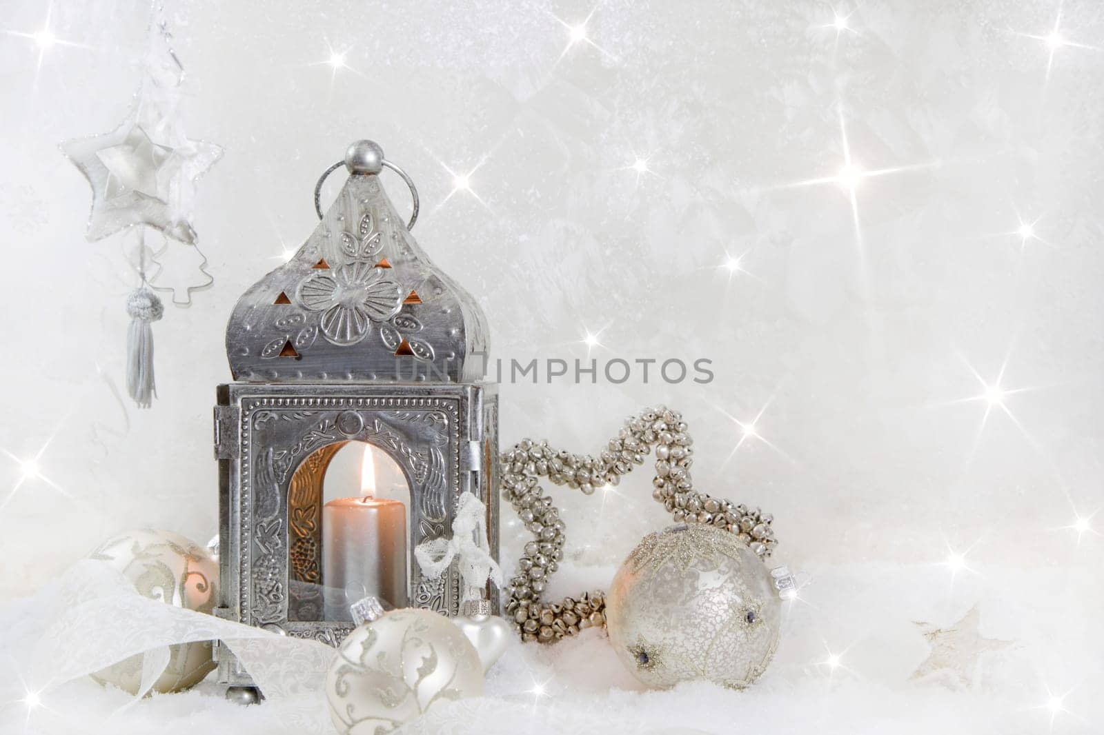 Christmas decoration with a latern in white and silver for a christmas card