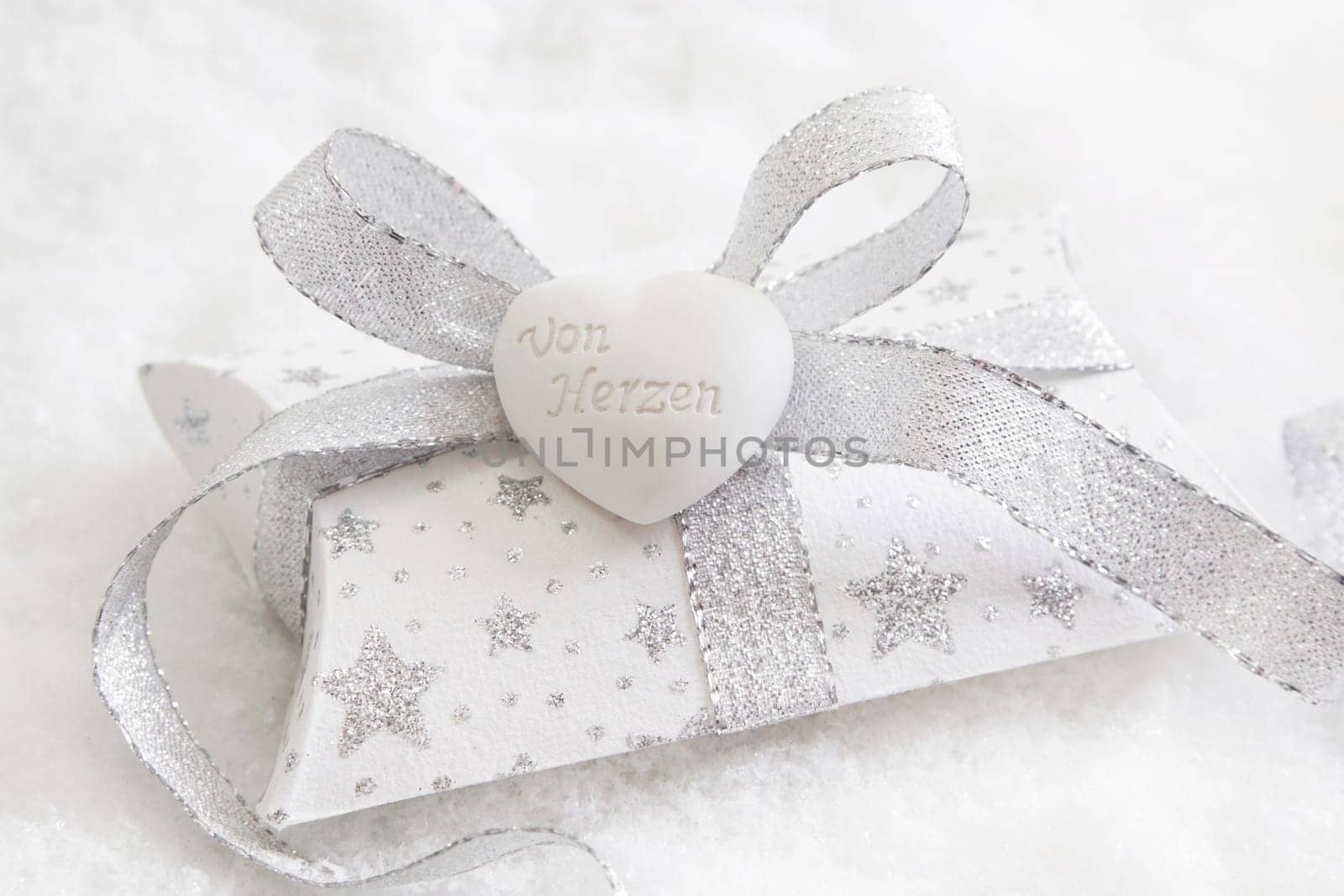 Top view of white and silver present box with white heart for christmas