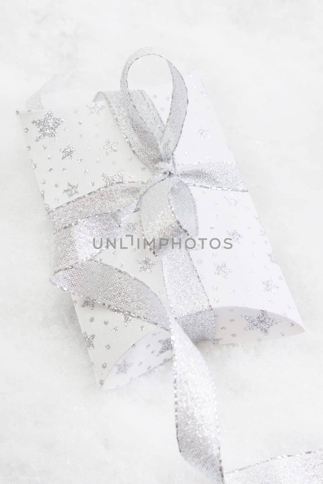 Close up of white present box with silver ribbon for christmas on white background