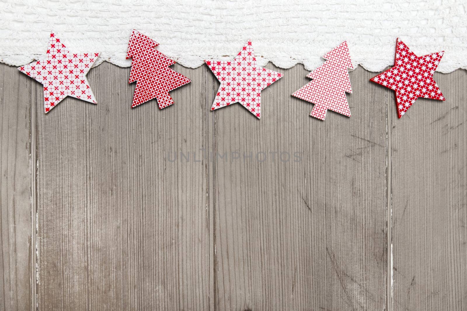Top view of star and pine tree decoration with crochet strip on wooden background for christmas
