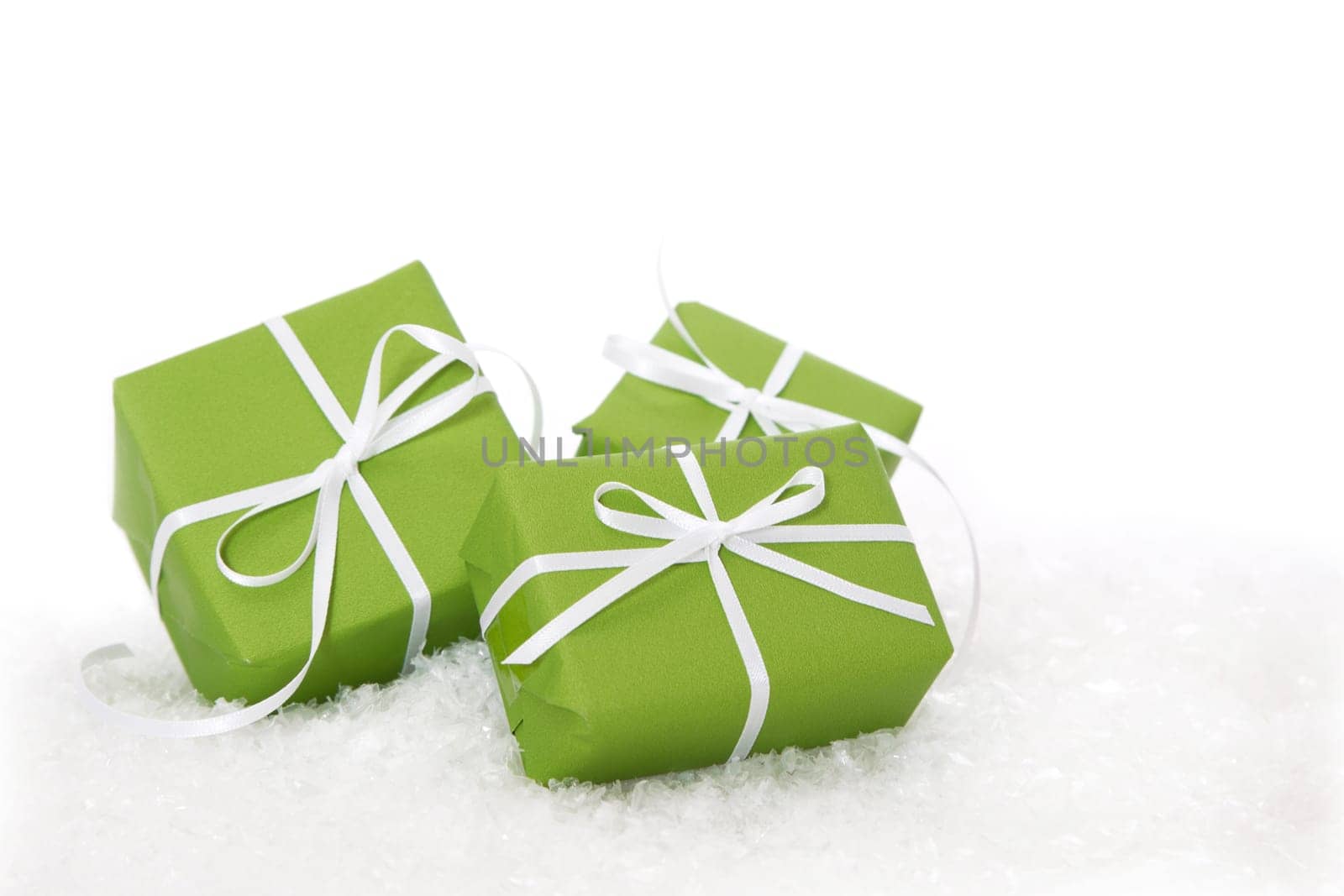 Three green gift boxes tied with white ribbon - present isolated for christmas or birthday or idea for a christmas card