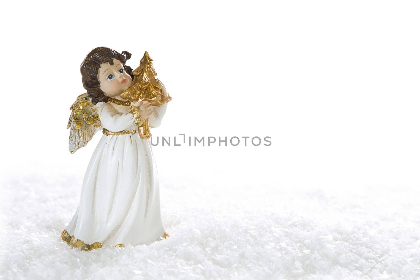 White golden christmas angel for decoration - isolated on white background with snow for a greeting card