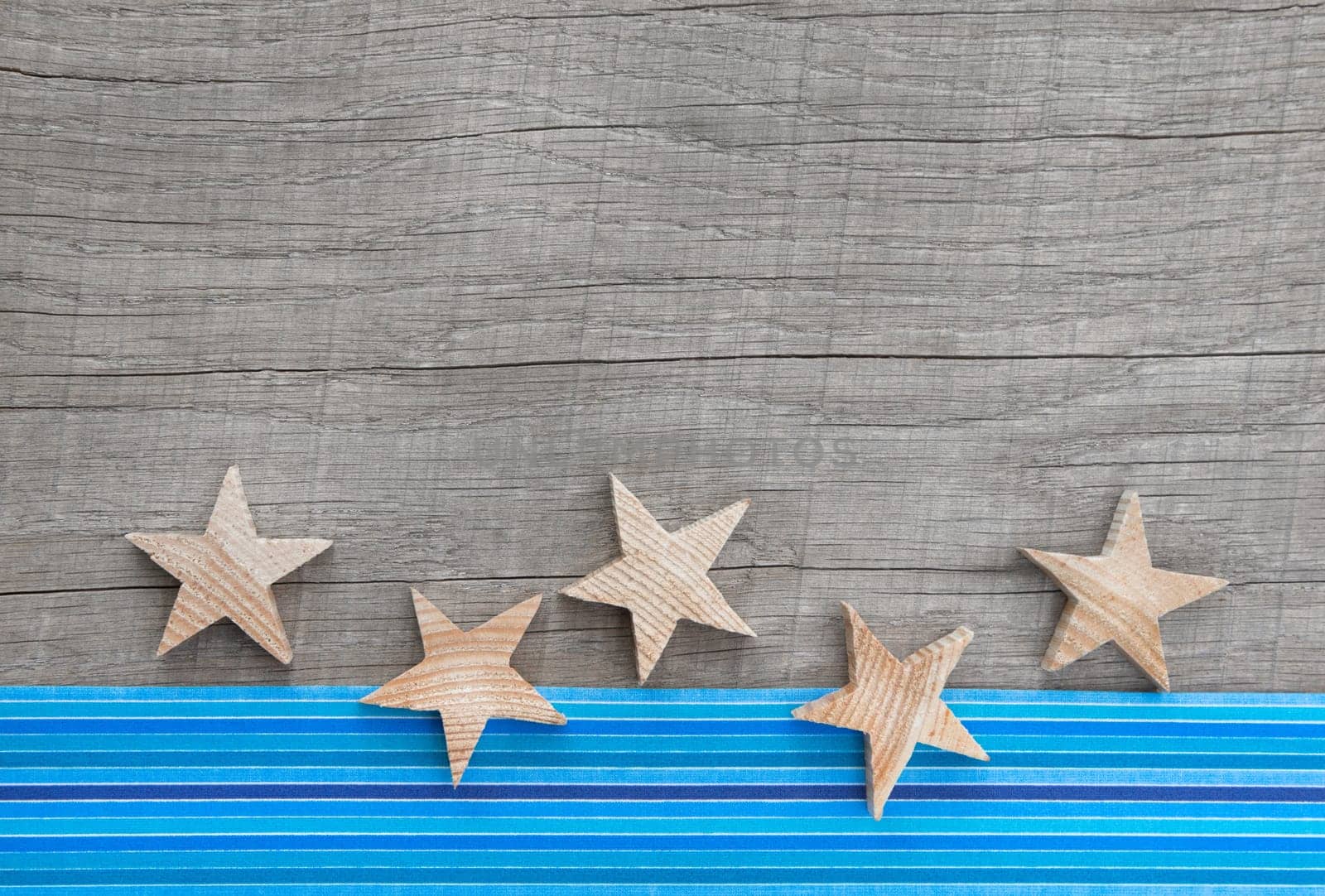 Christmas card with blue and white stars on a country rustic background