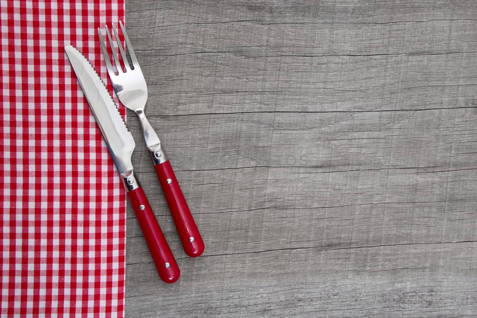 Knife and fork on wooden background for christmas, birthday, valentine's day, mother's day or for a greeting card - bavarian food or invitation
