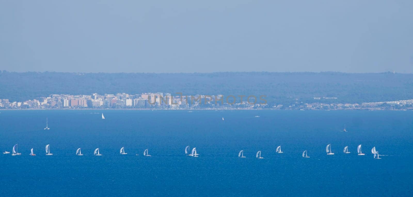 Sailing boat yacht or sailboat group regatta race on sea or ocean water. Panoramic view.