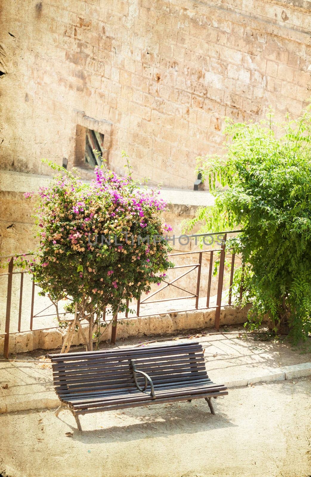 Vintage photo of an old fortress wall with a bench