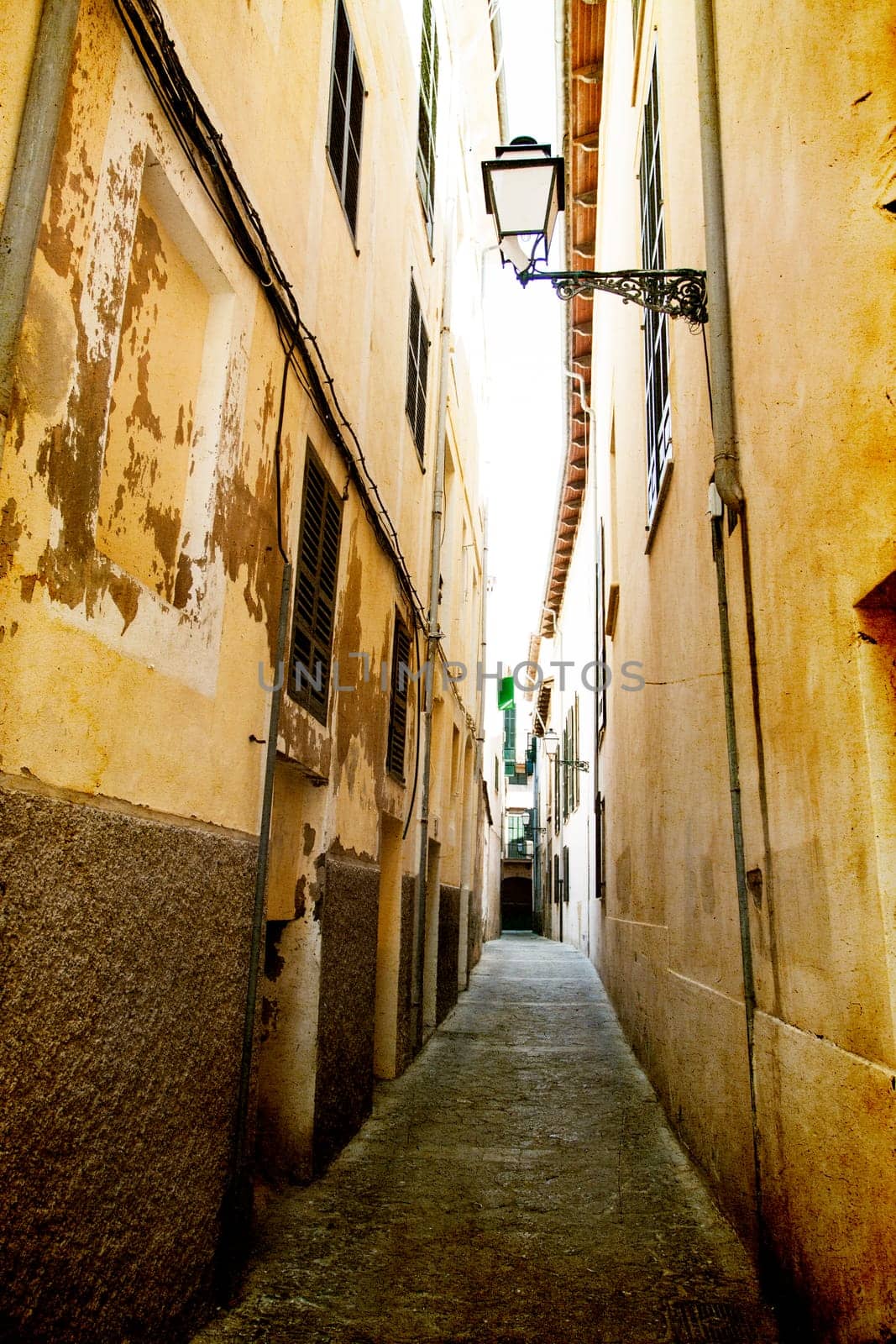 Narrow street in old city of Palma de Mallorca, Spain
