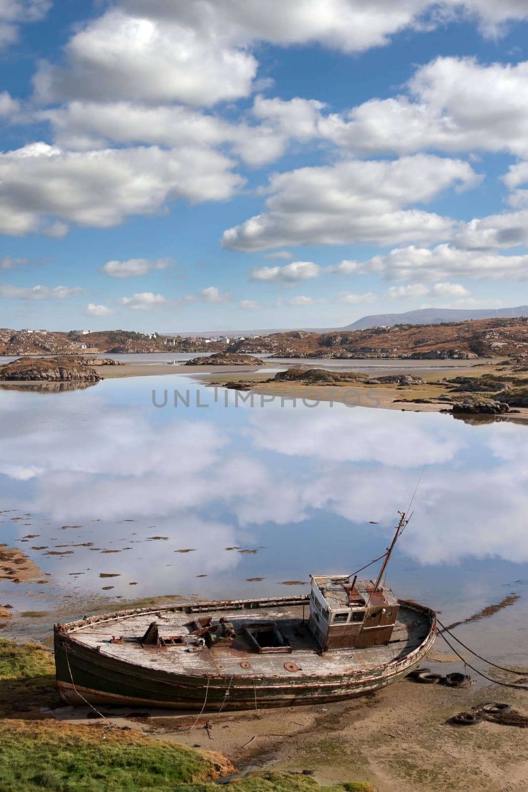 old fishing boat beached on a coastal beach in county Donegal, Ireland