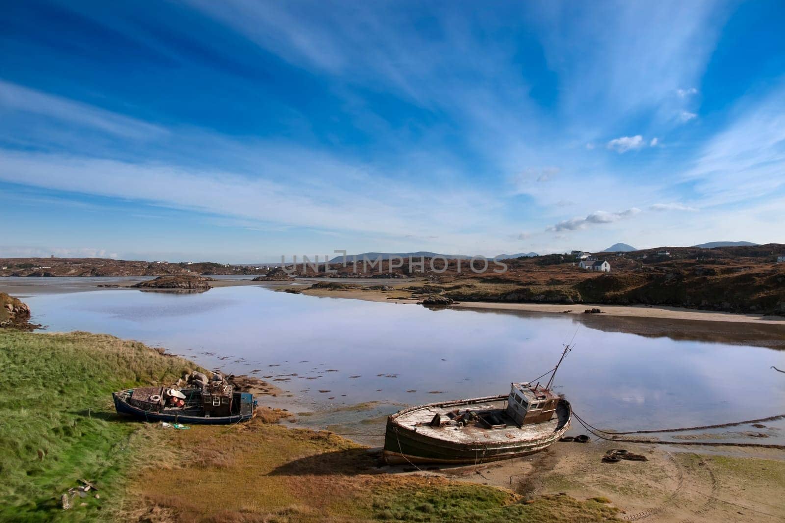 two old fishing boats beached on a coastal beach in county Donegal, Ireland