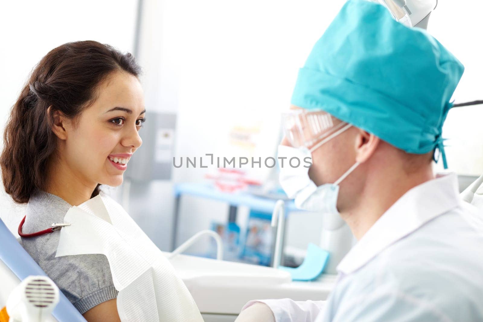 Young girl looking at her doctor in clinic