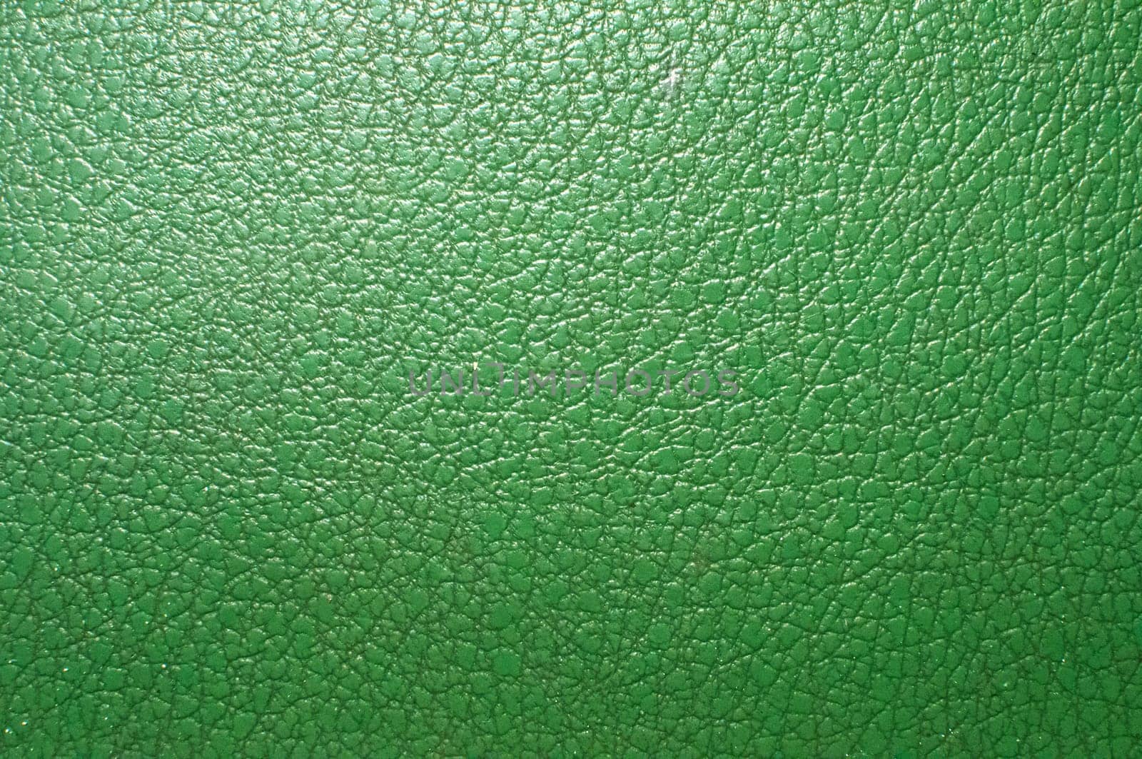 Green artificial leather surface closeup as background