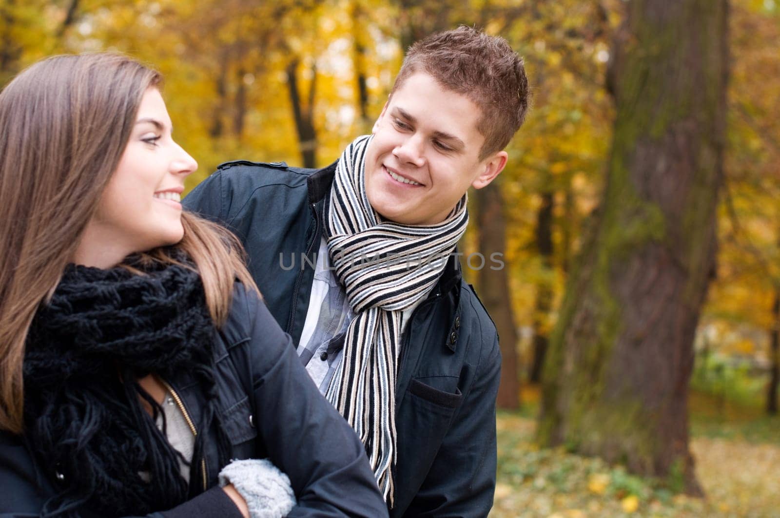 Young couple walking through the park