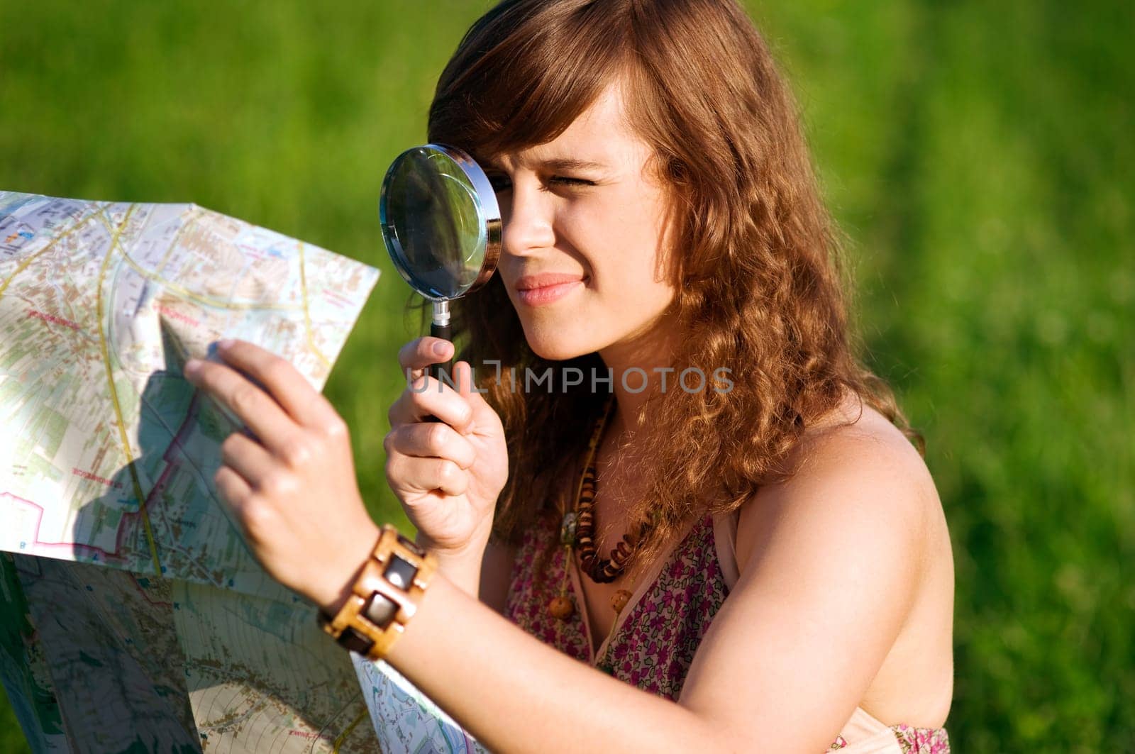 Beauty woman looking through magnifying glass