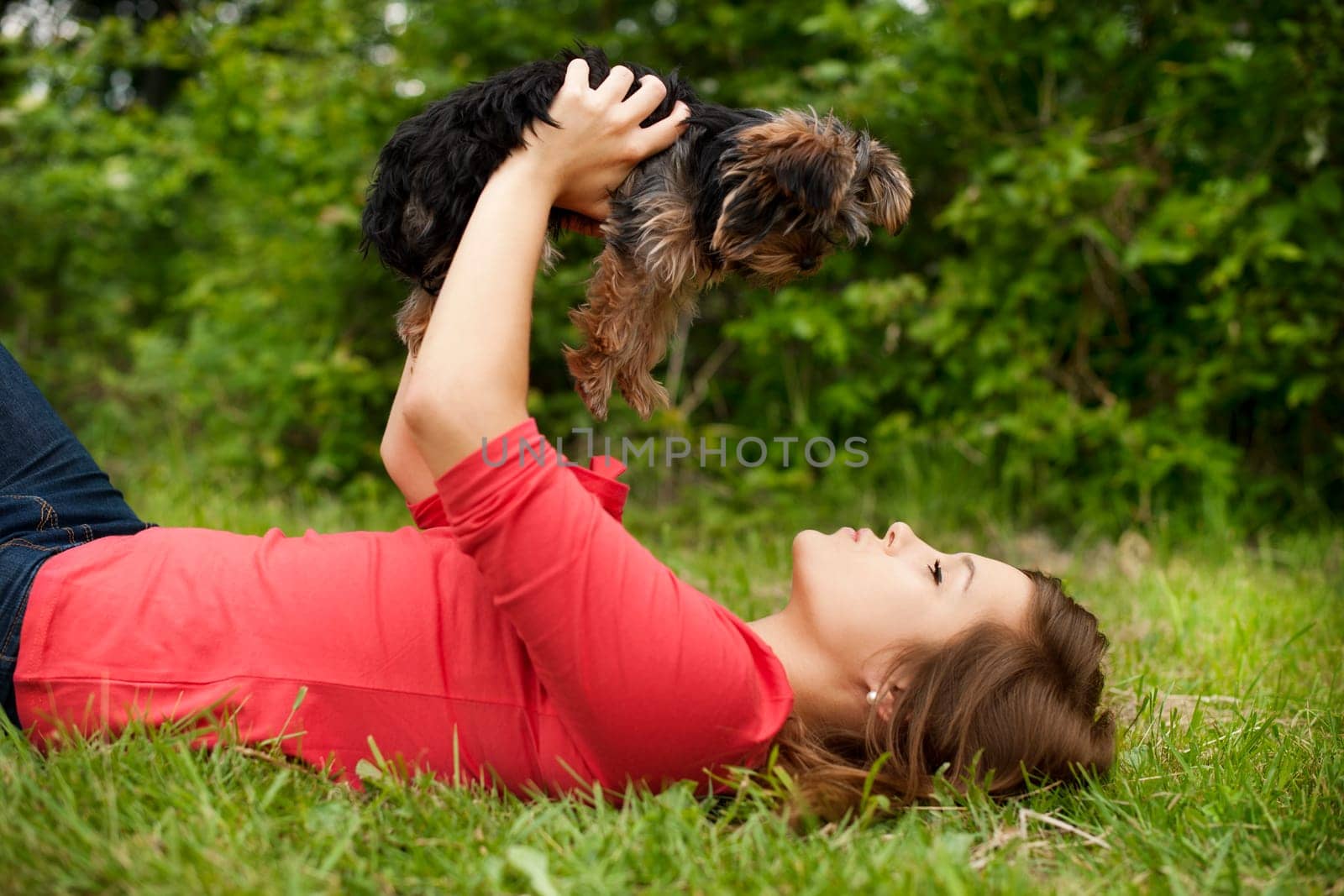 Young woman holding cute puppy