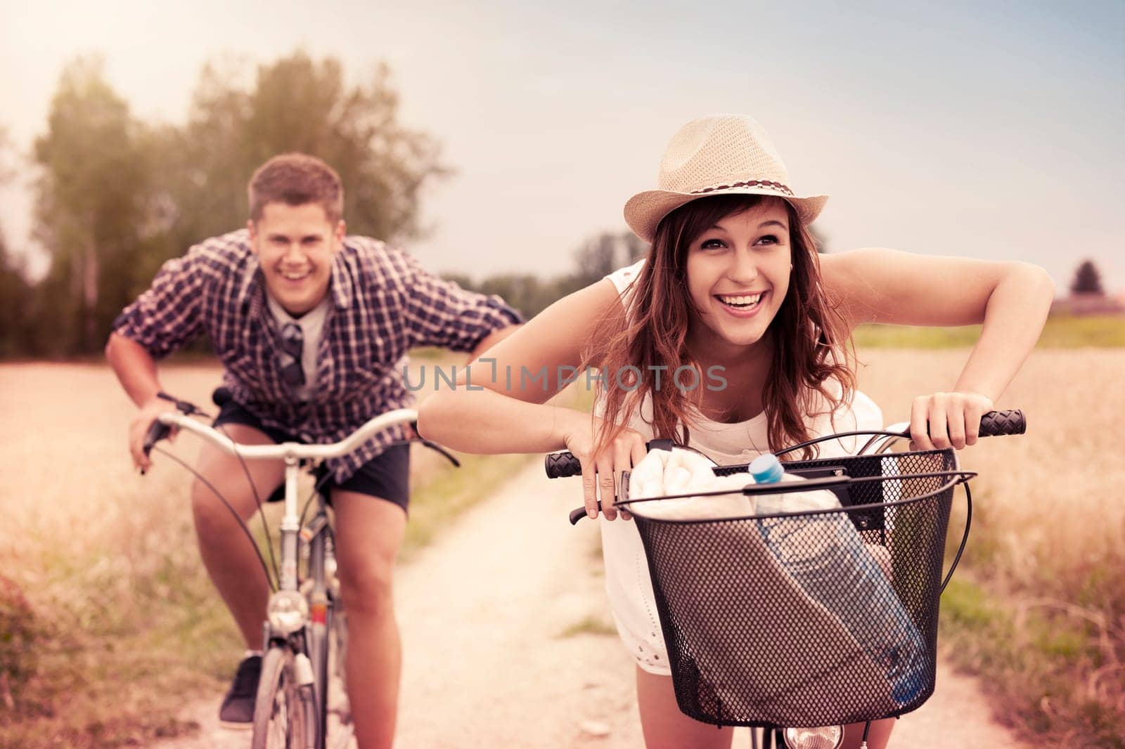 Happy couple racing on bikes