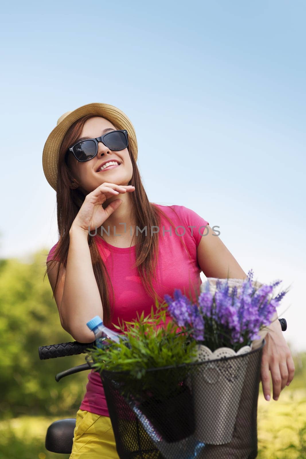 Portrait of beautiful young woman with bike