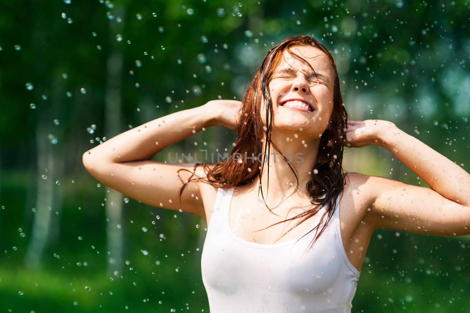 Happy young woman in raindrops