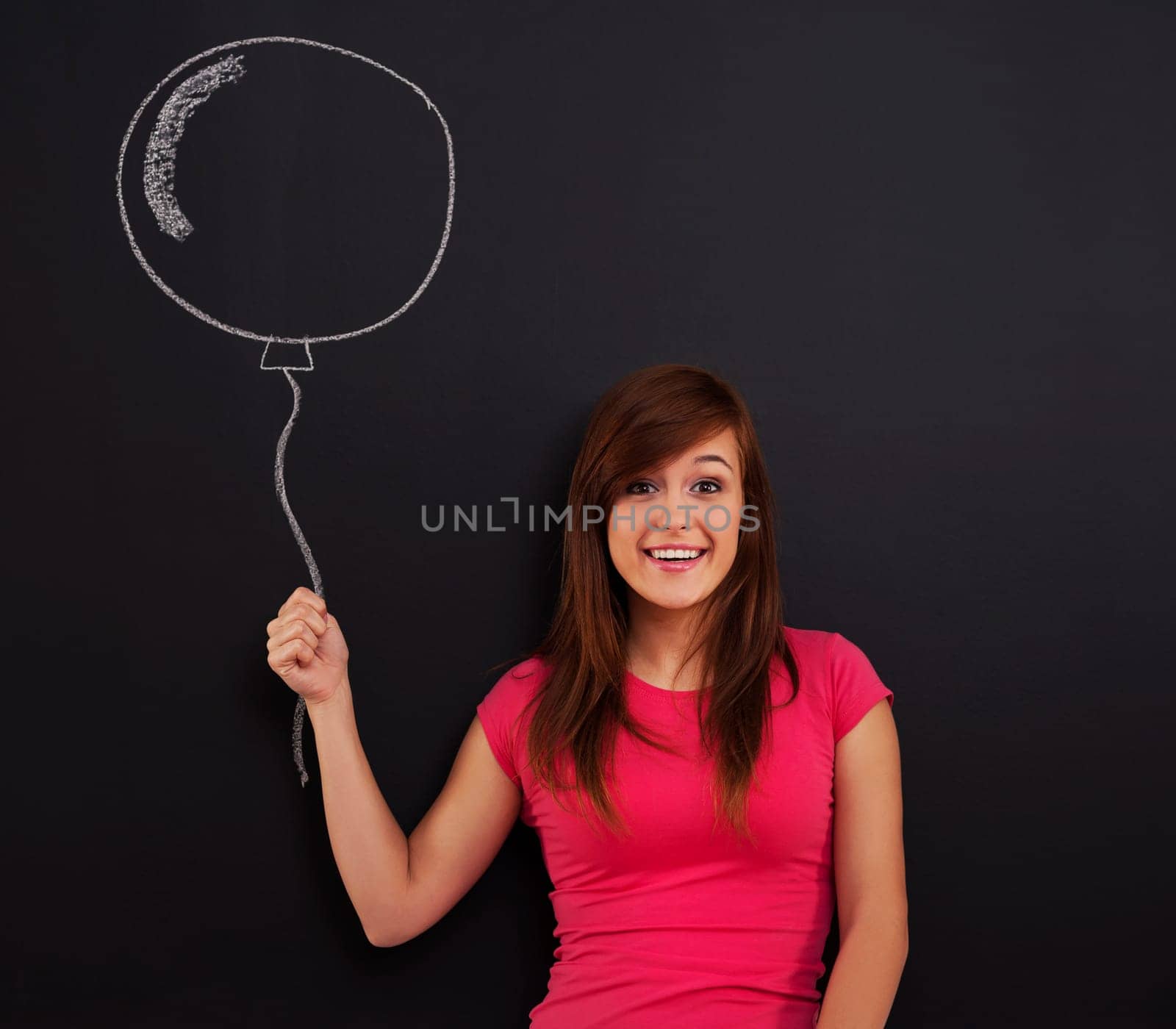 Smiling woman holding in hand balloon