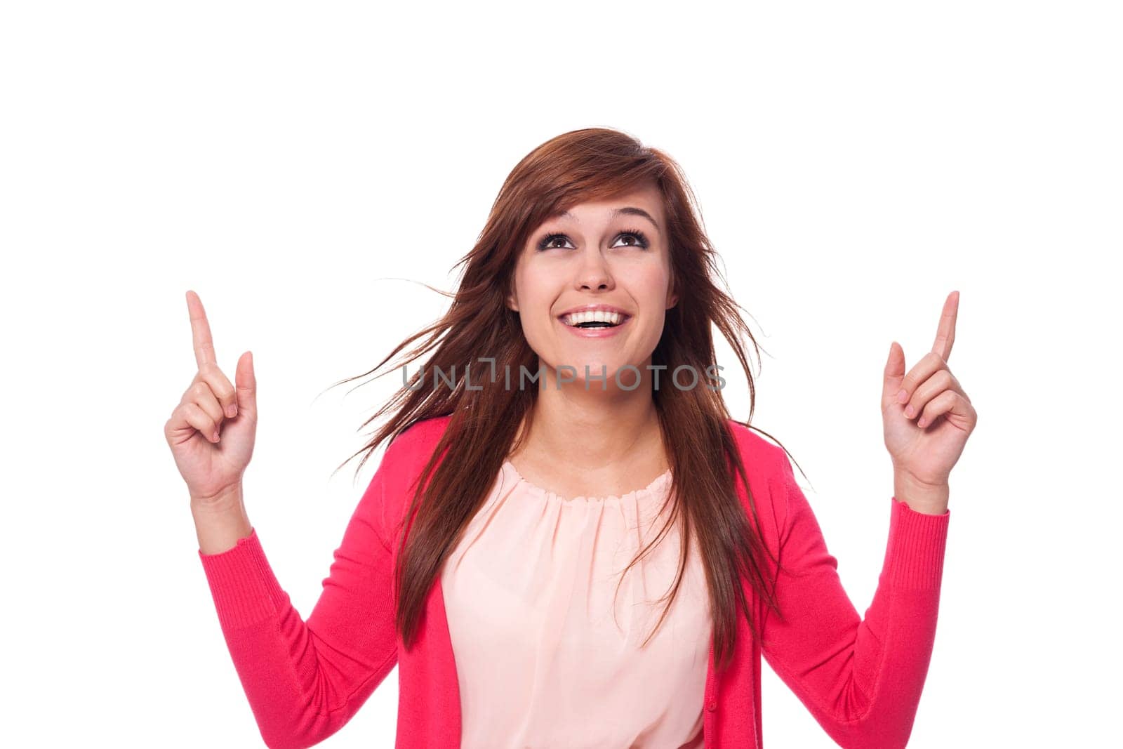 Young woman showing and looking at copy space