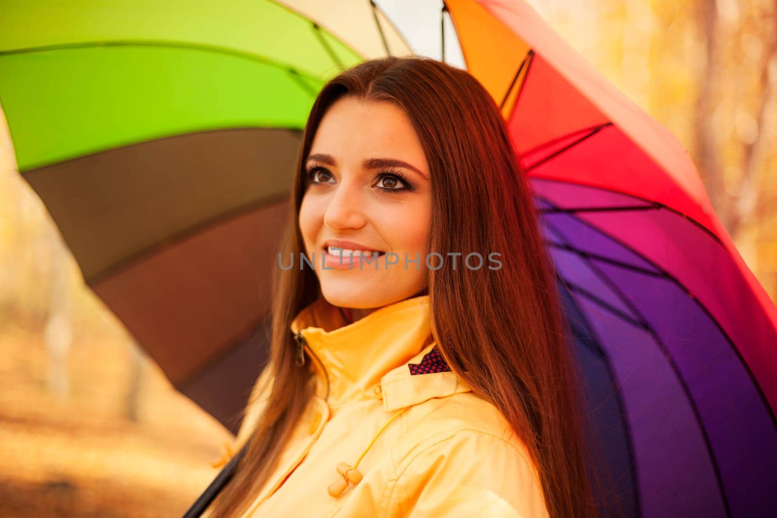 Smiling woman standing under the umbrella