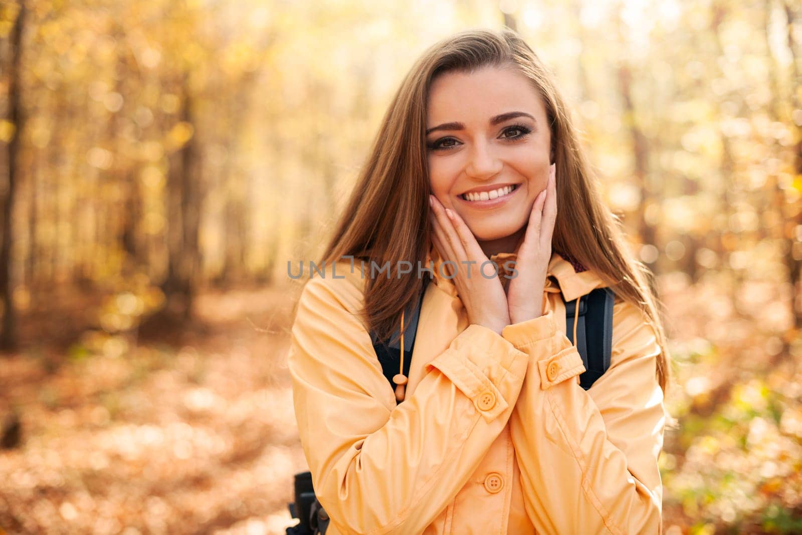 Portrait of young happy woman during the autumn hiking