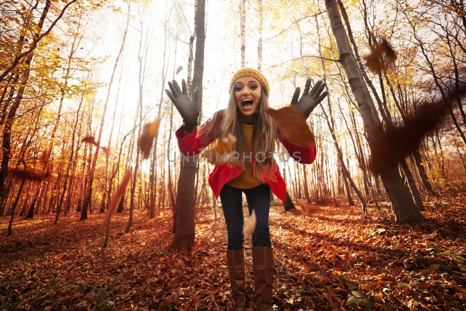 Young woman have fun with autumn leaves