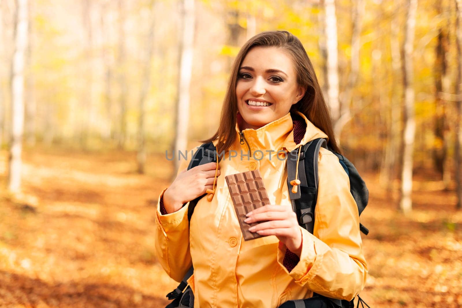 Smiling female hiker with dark chocolate