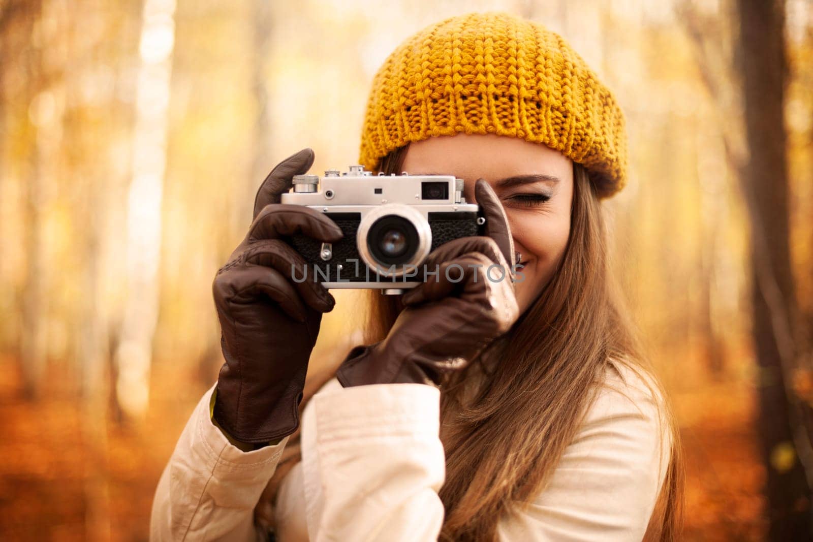 Woman taking photo by retro camera