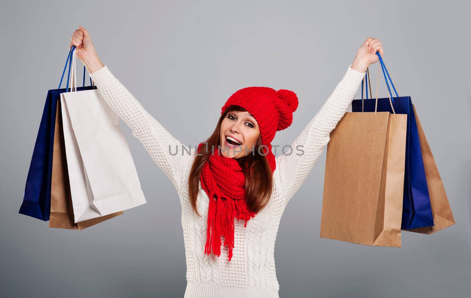 Excited woman holding a lot of shopping bag
